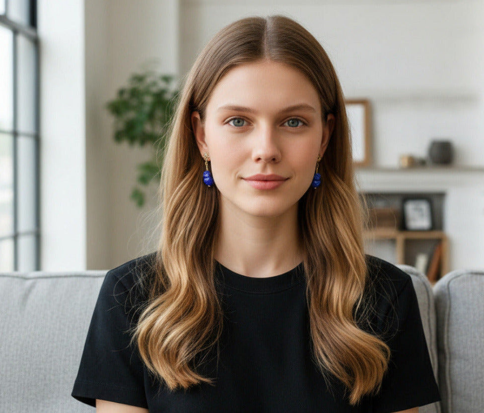 Close-up of a woman wearing a blue earring with a blurred background
