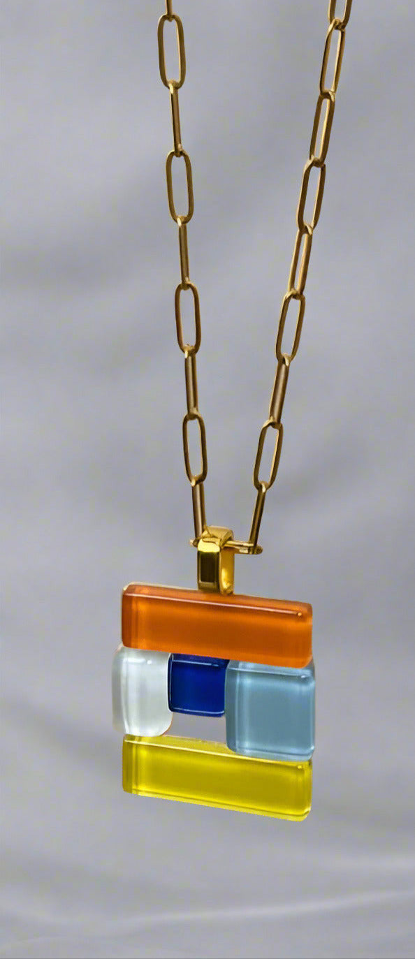 Necklace with a colorful square pendant on a beige background