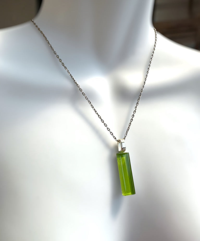 Necklace with a green bar glass pendant on a mannequin