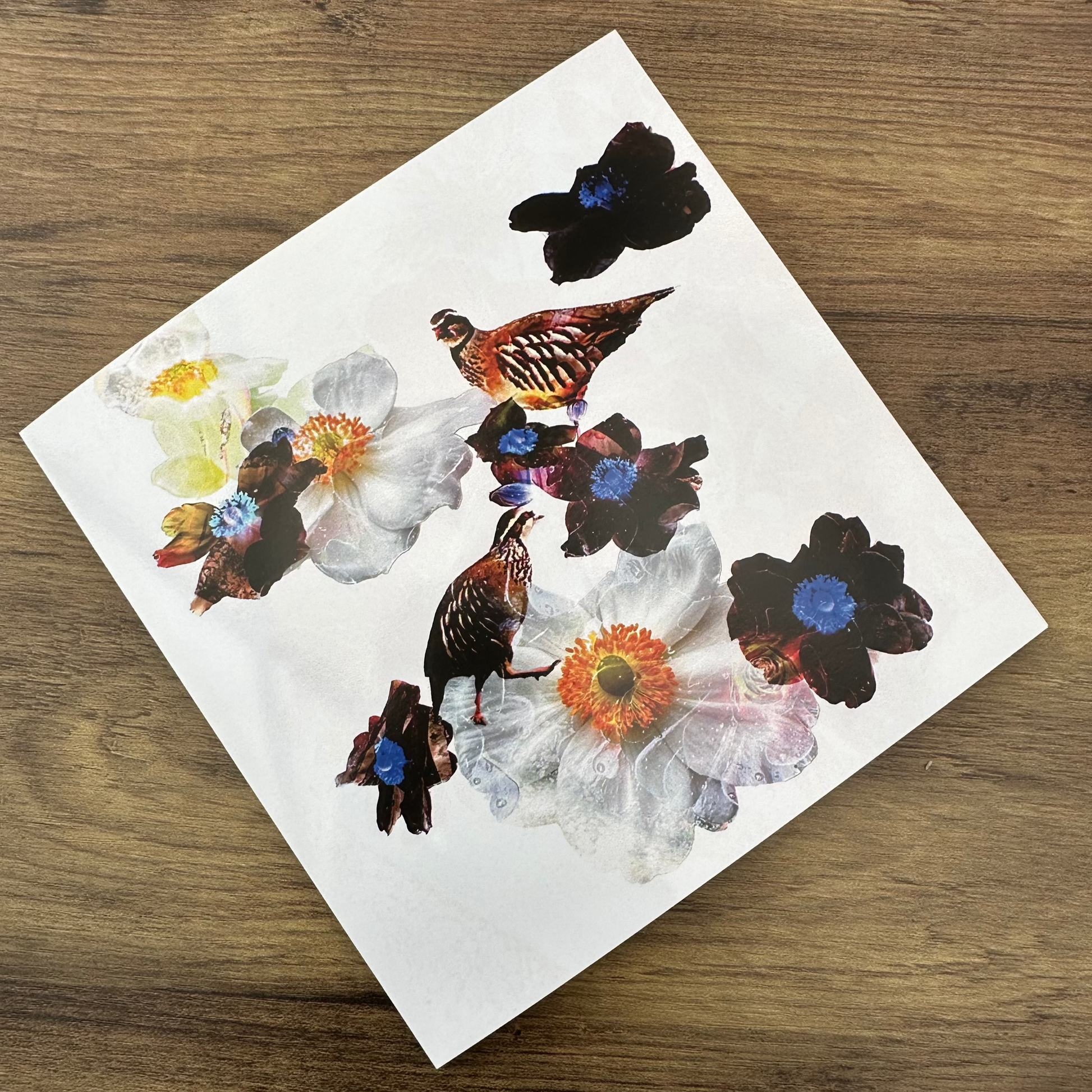 Floral white card with Partridges on a wooden surface