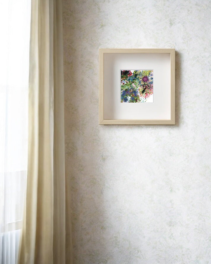 Framed floral artwork on a textured wall with a window in the background