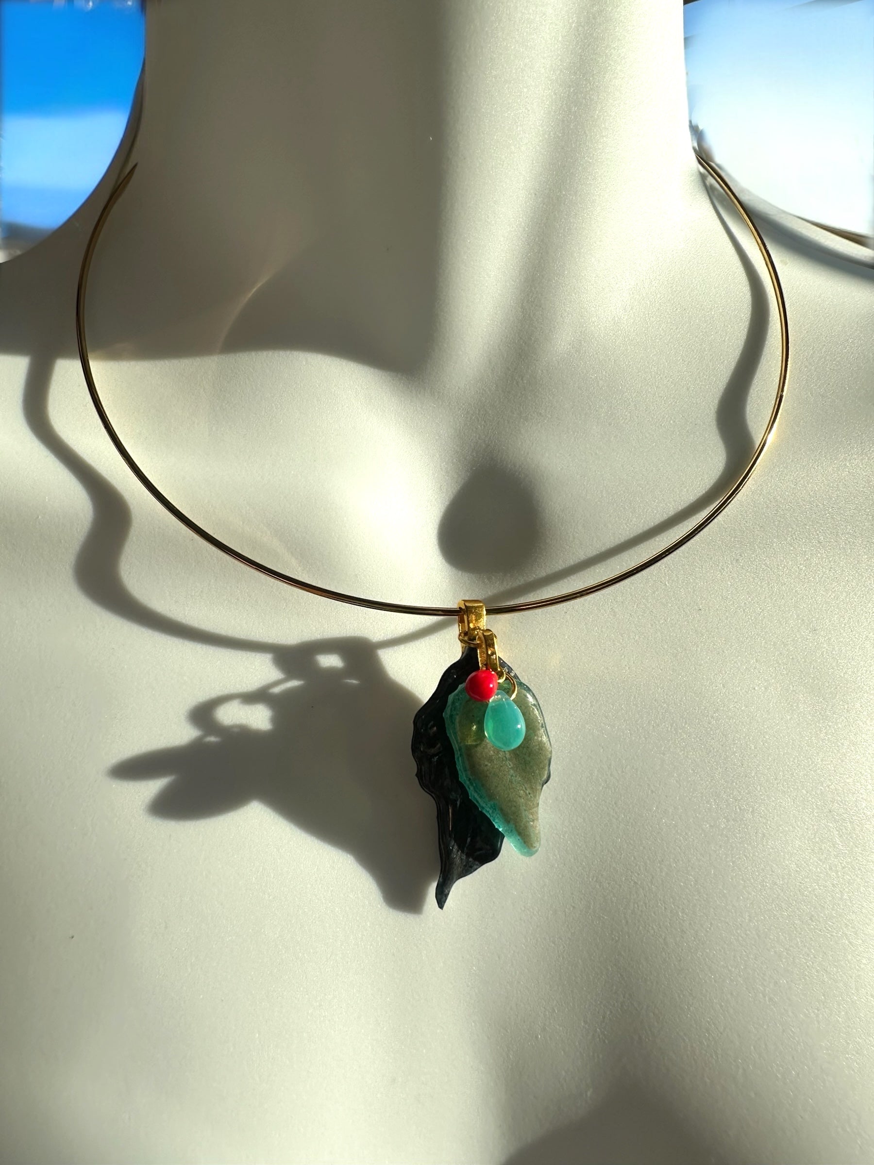 Necklace with a pendant on a mannequin neck against a white background